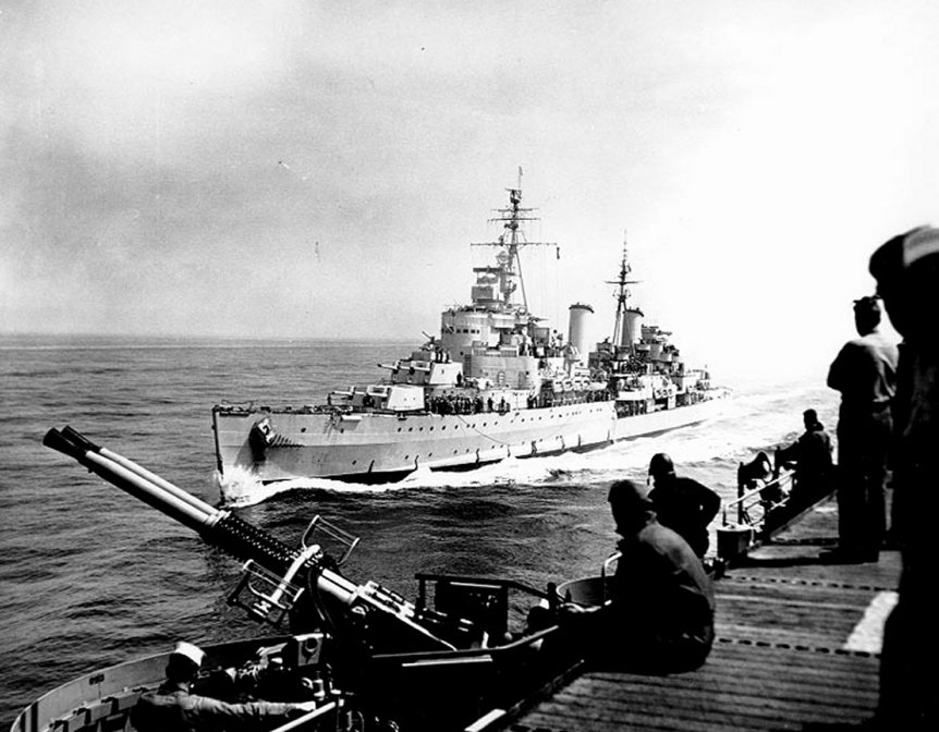 Belfast comes alongside USS. Bataan off Korea, May 1952