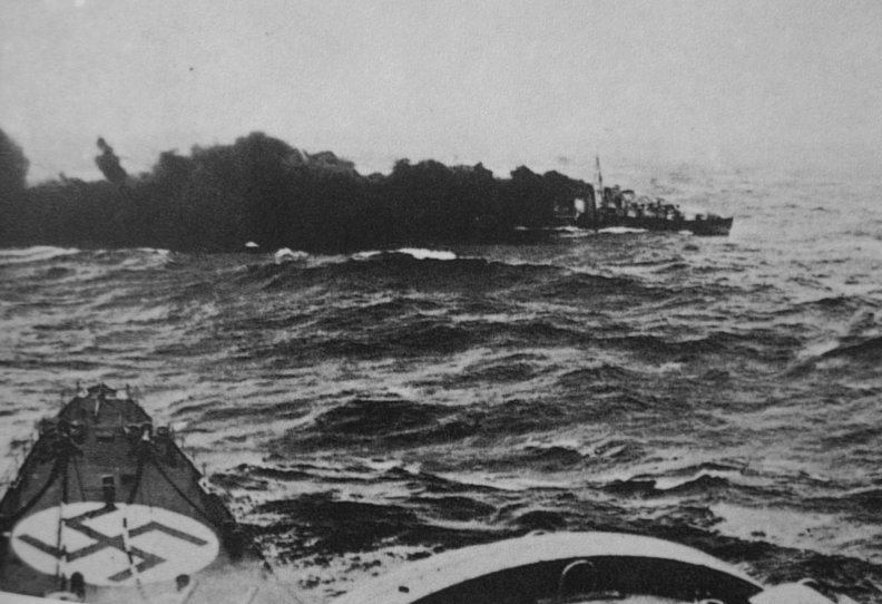 The Gloworm being sunk by the Admiral Hipper, who’s bows are in the foreground.