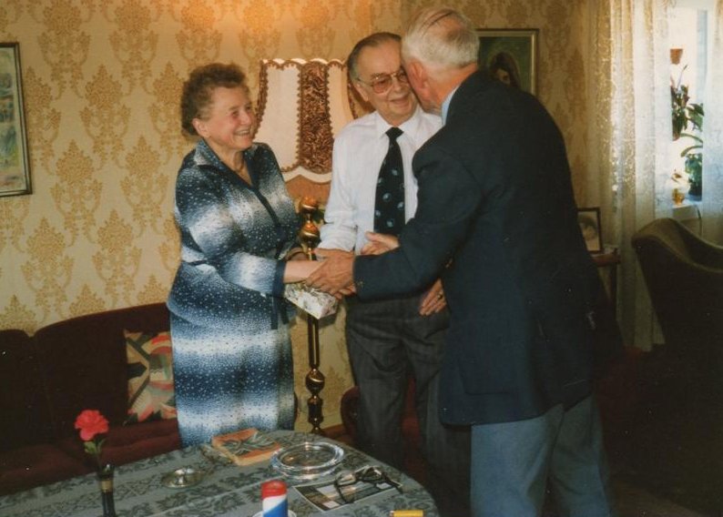 Mr. And Mrs. Haugland with Cyril Cope handing them a present from the family. Photo Ron.Cope.