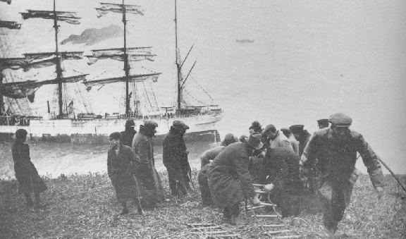 Coastguards rigging a rope ladder.