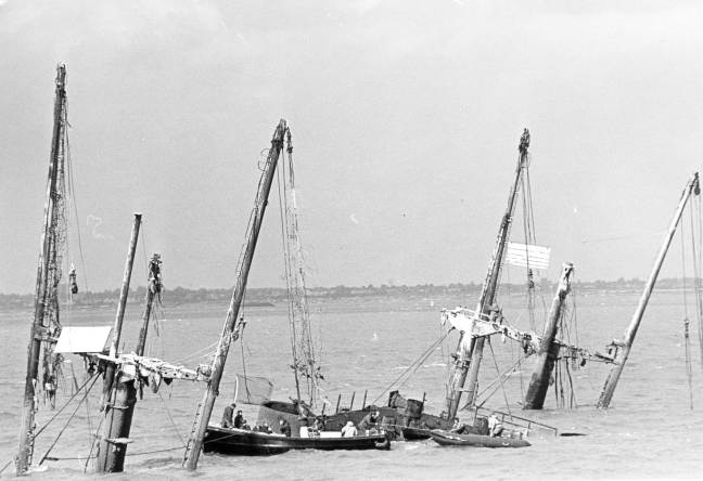 The Montgomery, with Navy Diver's inspecting the ammunition.